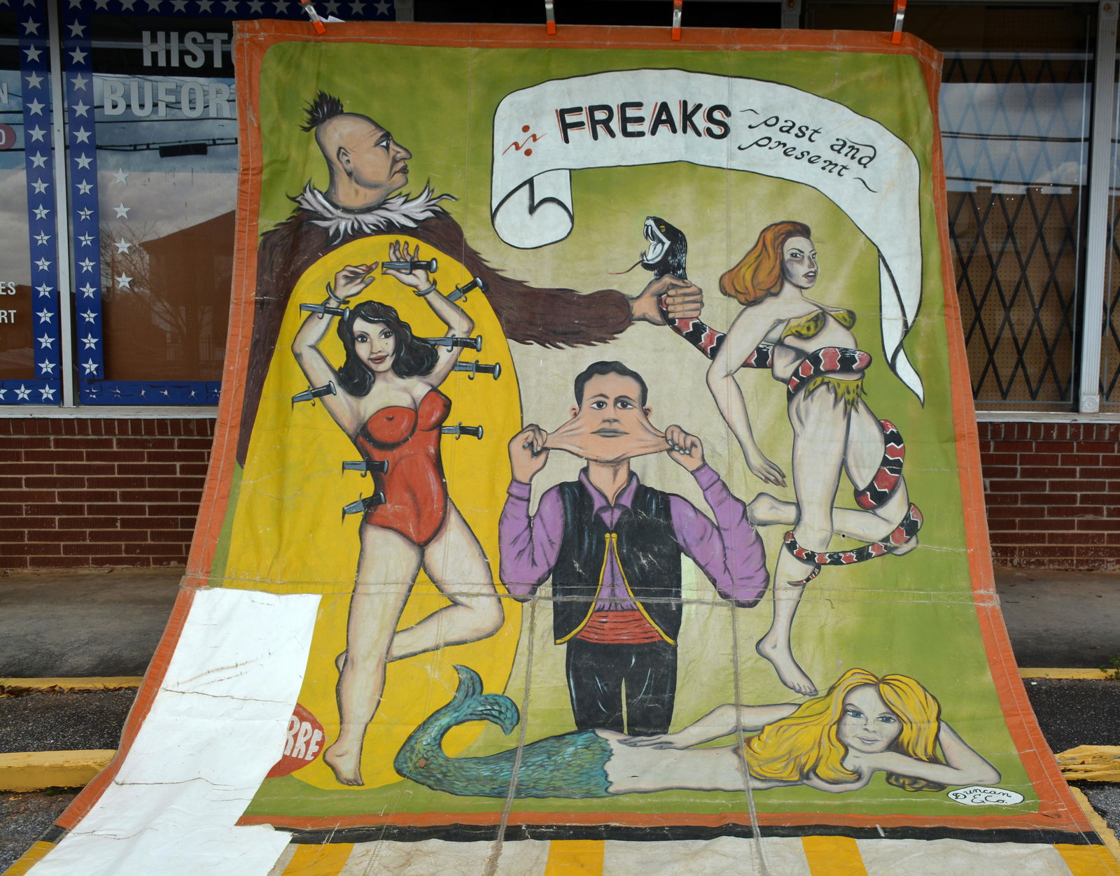 Duncan & Co. Freaks Past and Present Circus Banner.: Duncan & Co. Freaks Past and Present Circus Banner. c. 1960s. Extra large side show banner. Paint on heavy canvas, backed by vinyl. Expected wear and repairs, otherwise great condition. 117" x 183". E