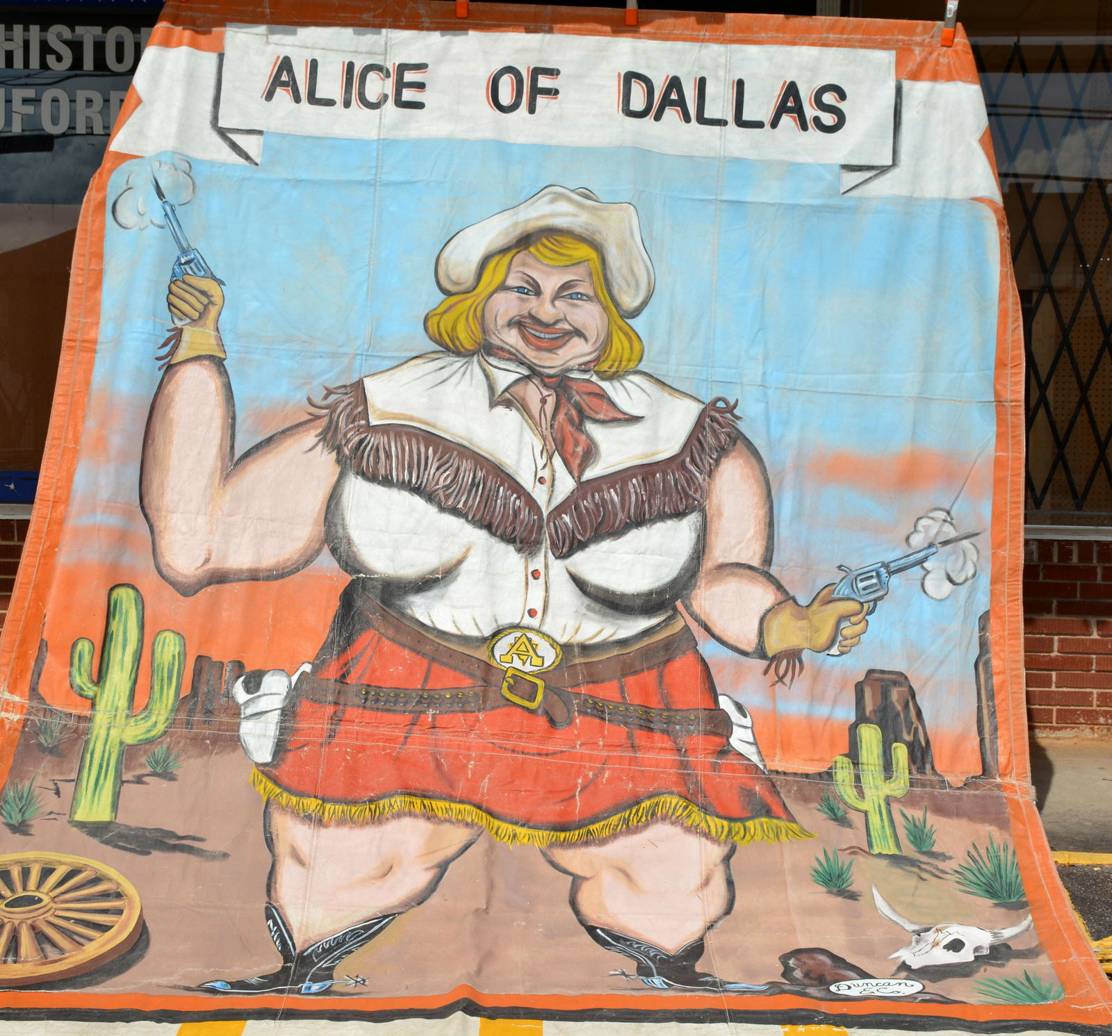 Duncan & Co. Alice of Dallas Circus Banner.: Duncan & Co. Alice of Dallas Circus Banner. c. 1960s. Signed and titled. Paint on heavy canvas backed with vinyl. Expected wear, overall great condition. 117" x 183". Est. $1,000-3,000. Ship: $150 (fo