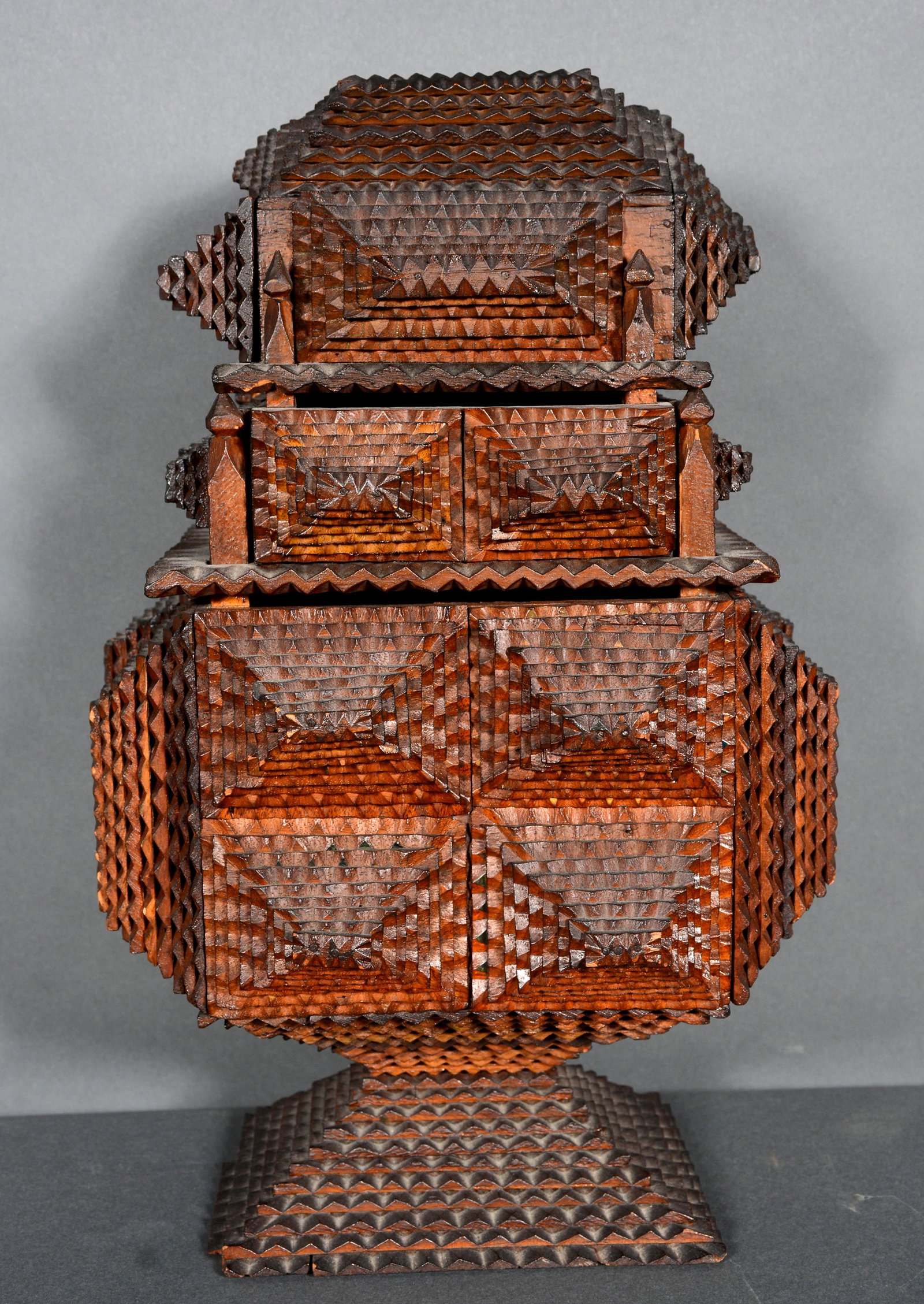 Three Story High Tramp Art Puzzle Box.: Three Story High Tramp Art Puzzle Box. c. late 1800s. Carved and stained nutmeg spice boxes. Minor chip on base, otherwise excellent condition. 15" h x 8.5" x 10". Provenance: ex. Jeff Louis Collectio
