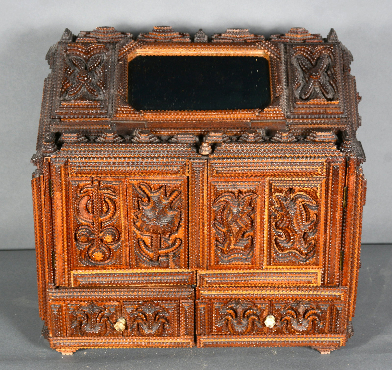 Keep Safe Tramp Art Box With Mirror and Secret Lock.: Keep Safe Tramp Art Box With Mirror and Secret Lock. c. 1900-1920s. Carved and stained wood with abstract designs. Excellent condition. 18" h x 19.5" w x 11.5" d. Est. $1,000-2,000. Ship: $125