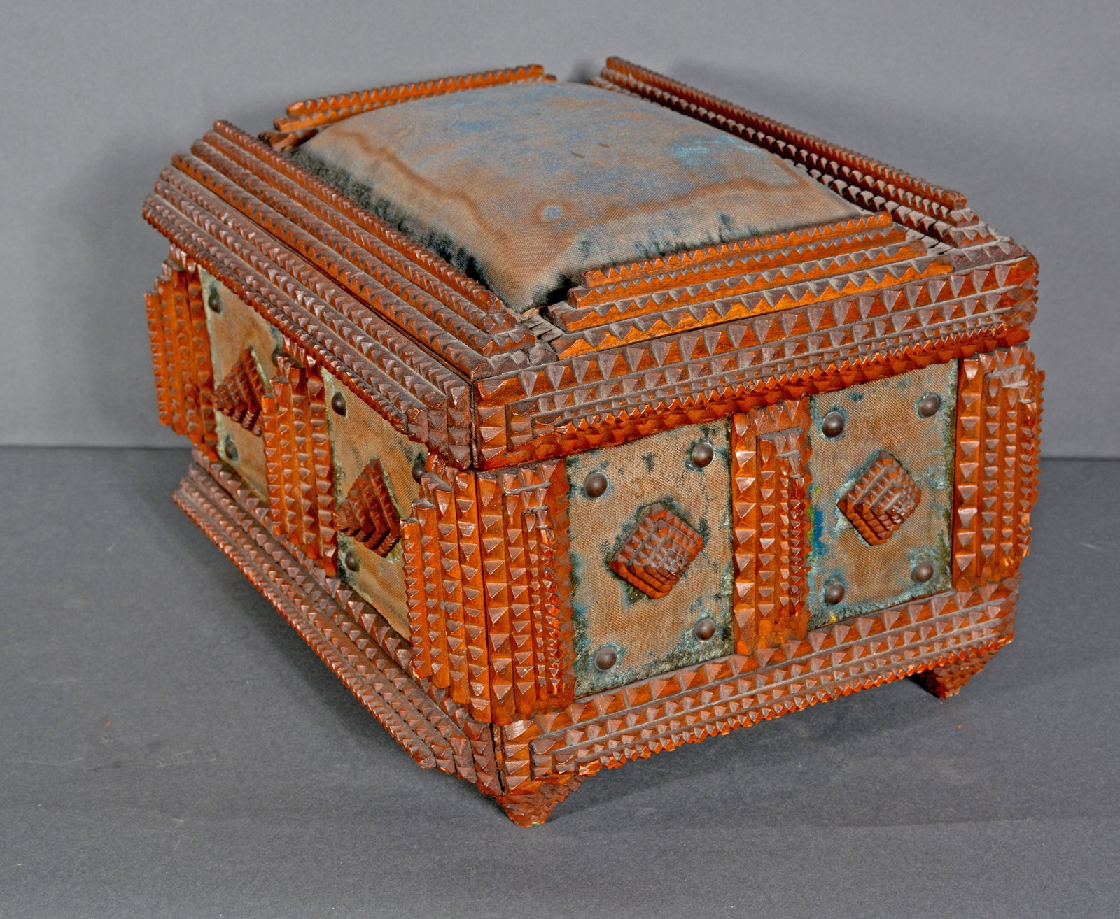 Tramp Art Sewing Box.: Tramp Art Sewing Box. c. 1900. Carved and stained wood with pin cushion top. Fabric is well worn, otherwise good condition. 9.5" h x 14.5" x 11.5". Est. $300-500. Ship: $55