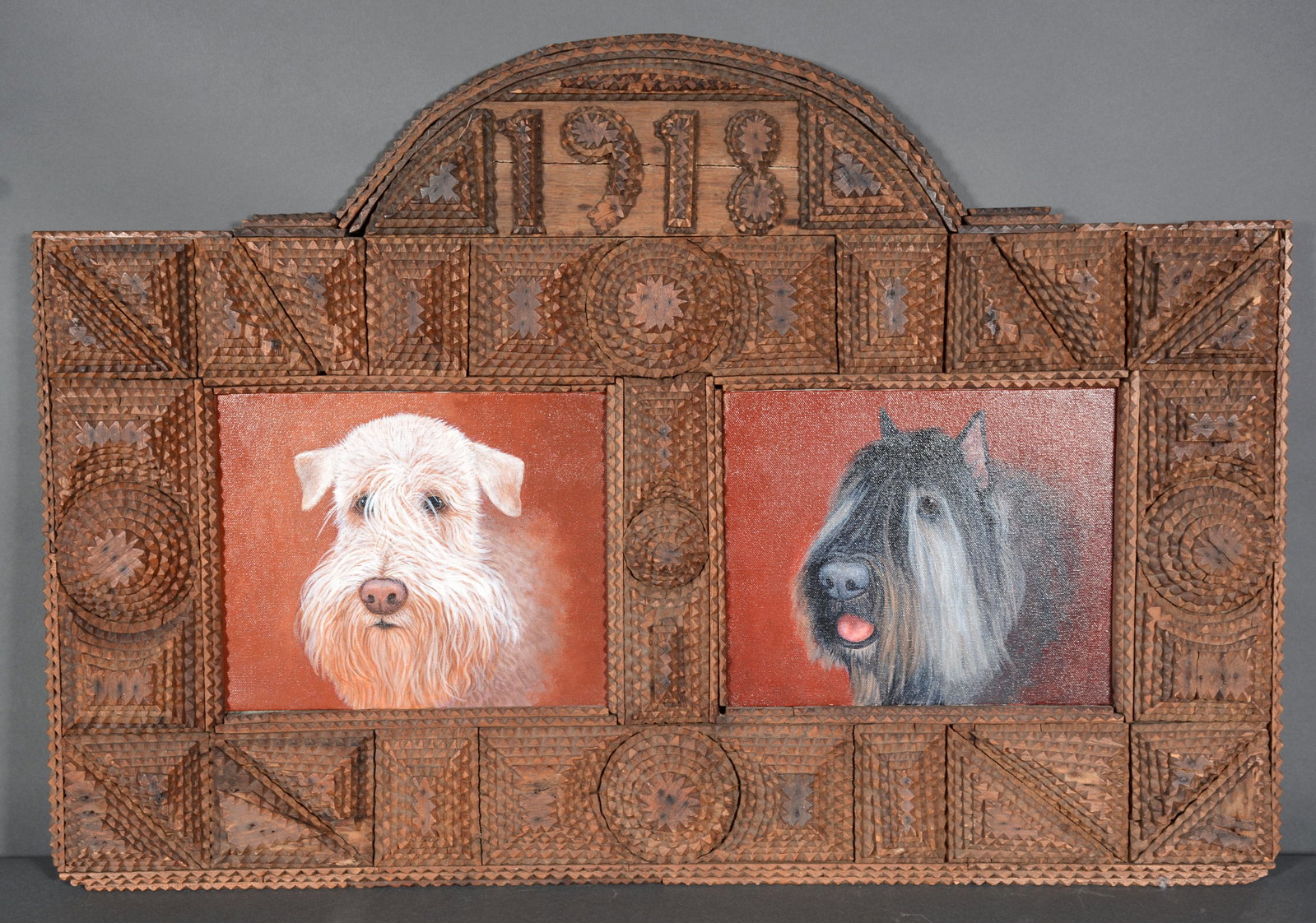 1918 Large Tramp Art Frame.: 1918 Large Tramp Art Frame. Carved and stained frame with multi-shapes. Loss to number 9 and lower triangle, otherwise great condition. 2 internal frames are 8" x 9" each, total size is 30" w x 21" h.