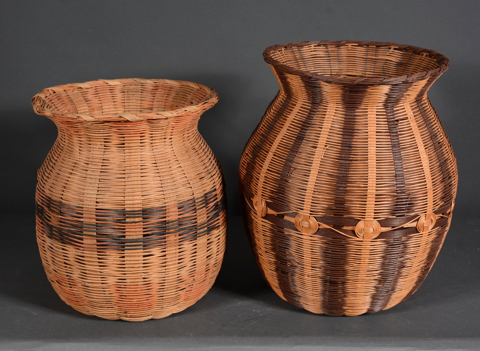 Lucy George. Cherokee Honeysuckle Baskets.: Lucy George. Mother & Daughter Cherokee Honeysuckle Baskets. Not signed. Attributed. Not dated. Honeysuckle vines and natural stains. Excellent condition. Tallest is 13" h.