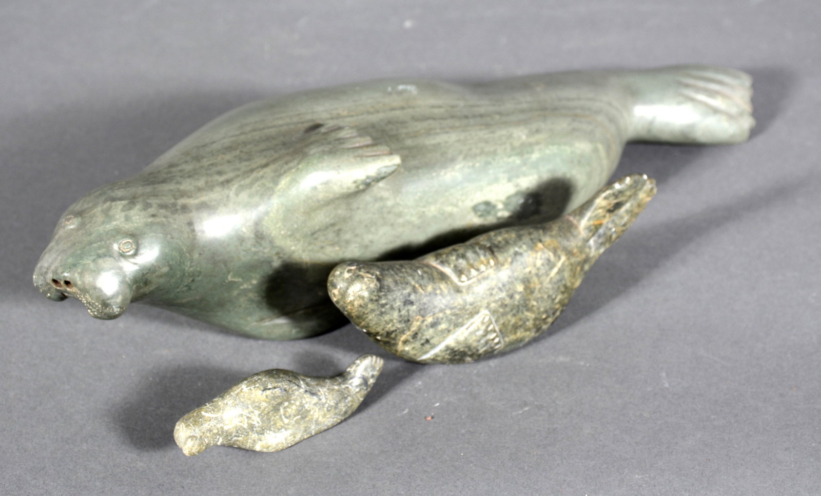 Joe Willie Echalook. Three Inuit Soapstone Seals.: Joe Willie Echalook & Inuit Artist. Three carved soapstone seals. Signed and numbered. Minor scratches and rubs, otherwise good condition. Largest is 3" x 15". Est. $300-500. Ship: $45