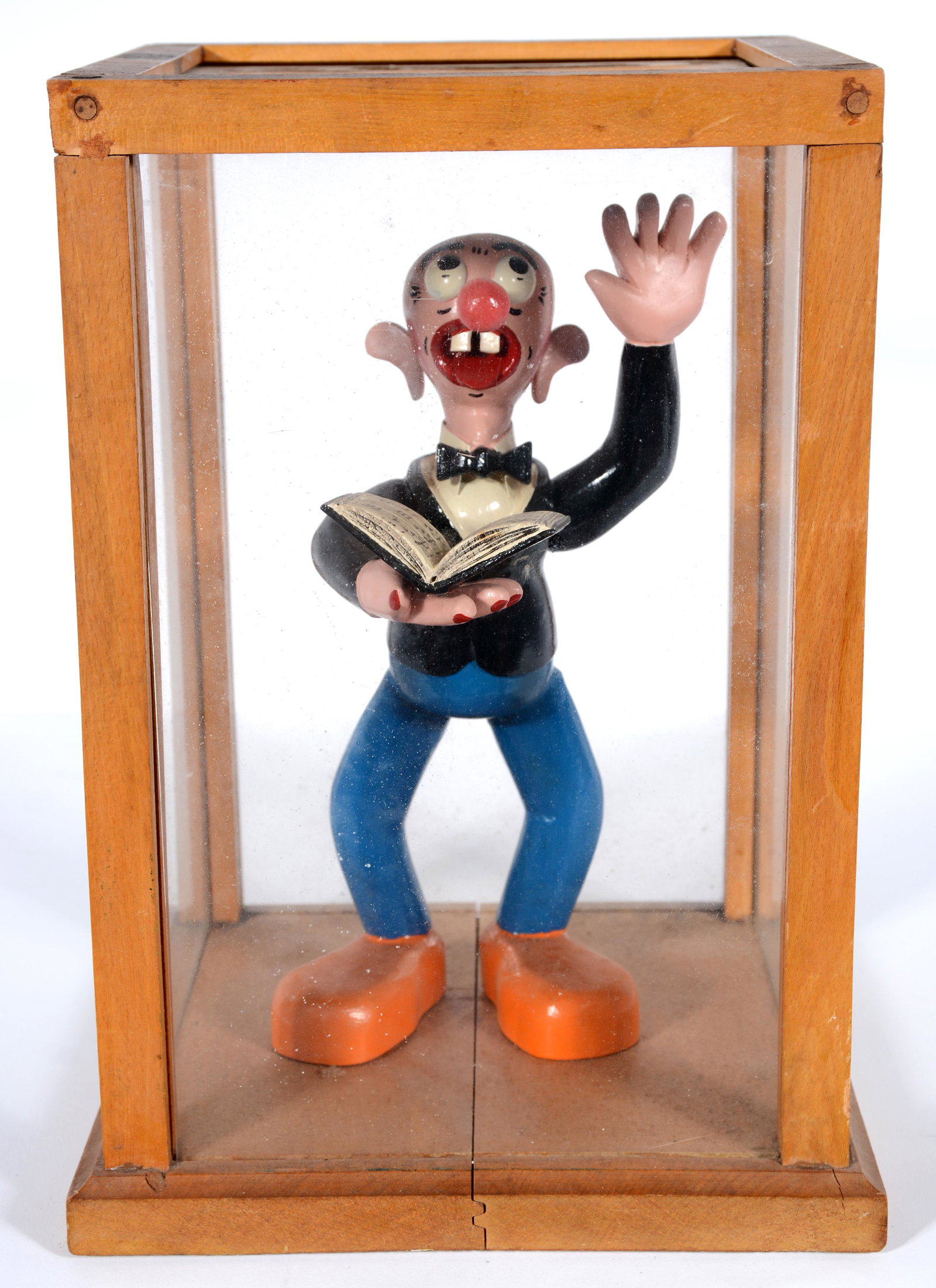 Singer with Song Book (in Vetrine).: Singer with Song Book (in Vetrine) c. 1940s. Carved and assembled wood and glass with paint and varnish. Humorous 'pop' folk art. 11.5" h x 8.5" x 8". Great condition. Est. $200-400. Ship: $45