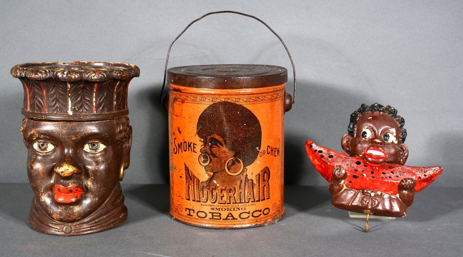 Anonymous Stereotypical Memorabilia of the Period.: Anonymous Stereotypical Memorabilia. Niggerhair Tobacco, FCW 37 Humidor, Plaster Watermelon Eater. Tin can with graphic illustration. Humidor with good original paint. Overall good condition. Tin can 