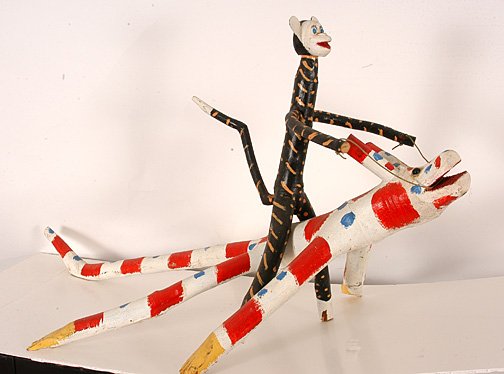 Edd Lambdin. Monkey Riding a Critter.: Edd Lambdin (b. 1935). Carved and painted wood, string. Signed on bottom. 37.5" x 23.5" x 22"h. Excellent condition. Est. $25-50. Ship: $85