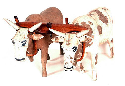 Pair of Oxen with Yoke.: Unknown artists. Carved and painted wood. Each is about 3.5" x 12.5" long x 7.5" h. Condition problems. Brown oxen is missing half his foot, right leg & tail. Horns have been repaired. Est. $10-20. Sh