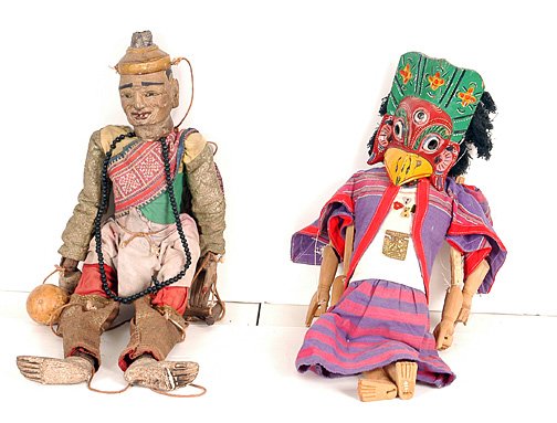 Pair of Puppets.: Unknown makers. One appears old and of Asian origin. Made of wood and fabric. 29.5" h x 12" w. The other may be South American and is wearing a carved, painted wooden mask. Both in good condition. Est