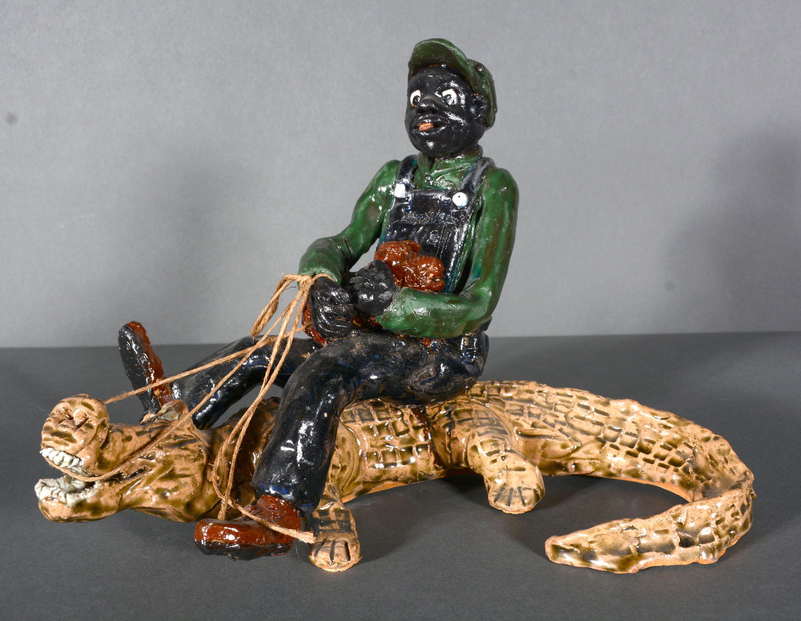 Man Riding Alligator Ceramic Sculpture. (1 of 3)