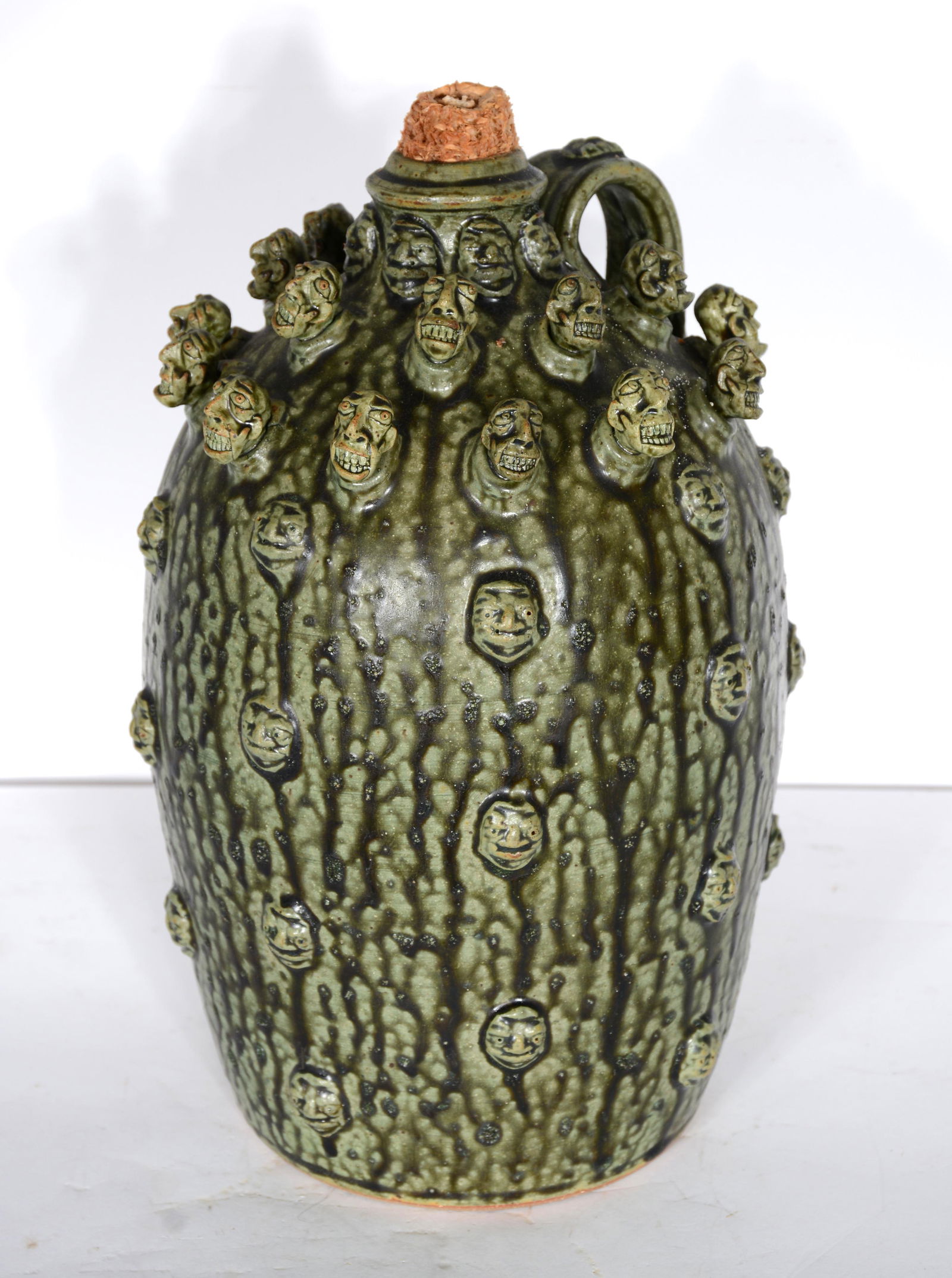 Sid & Stacy Luck. Multi-Faces on Liquor Jug. (1 of 3)