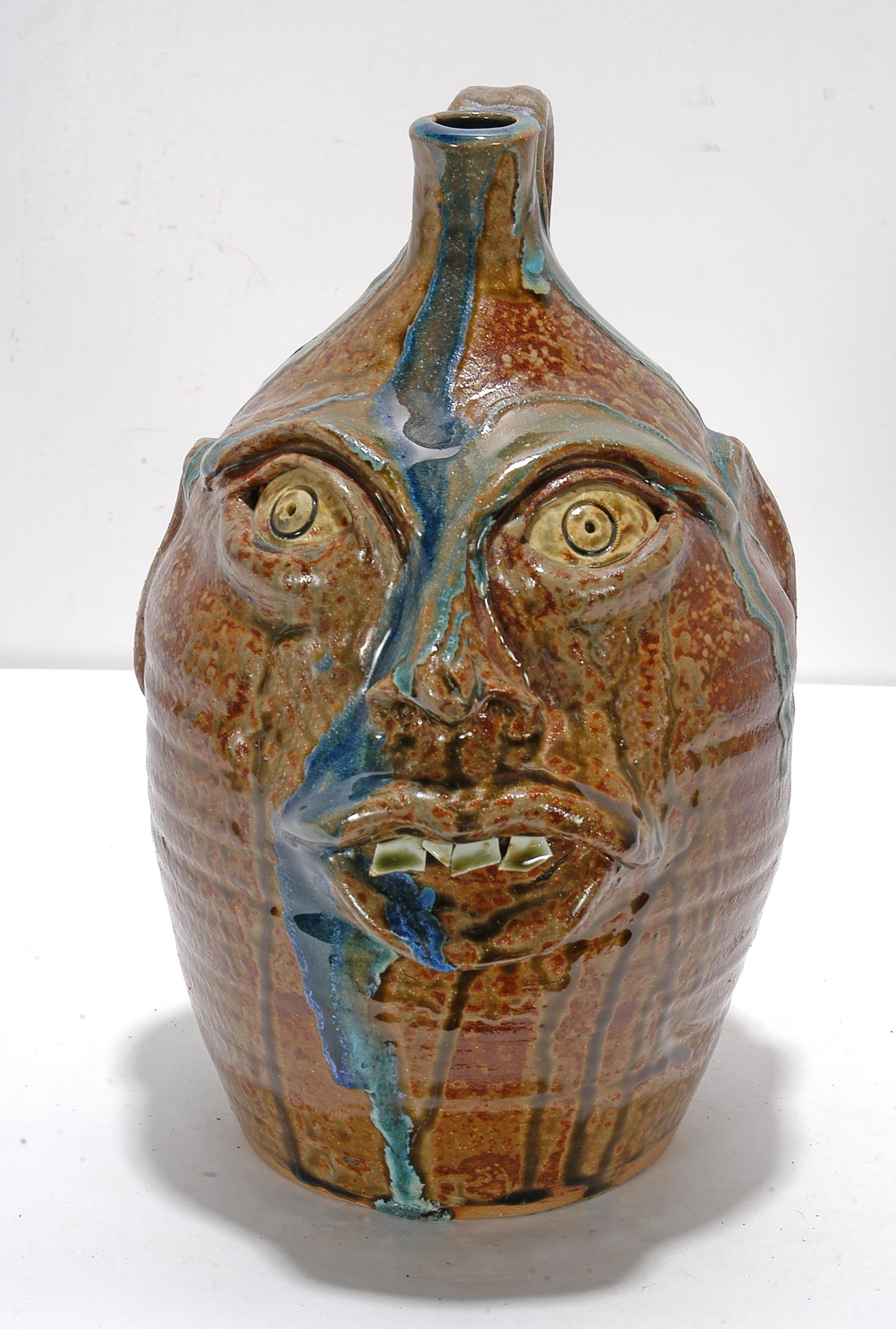 William Flower. Face Jug With Blue Glass Drips. (1 of 1)