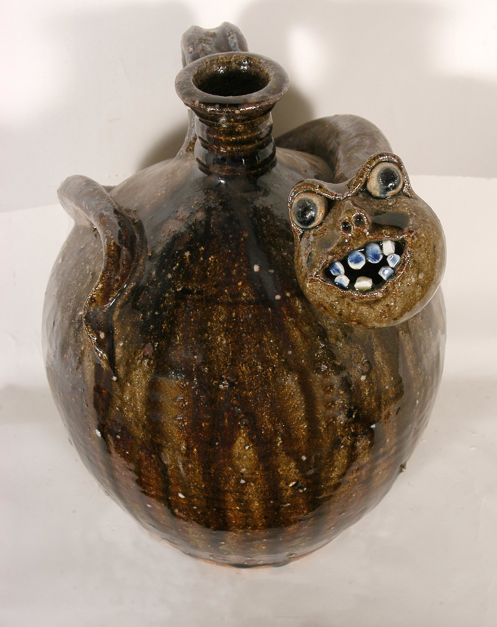 Michel Bayne. Snake Jug.: Michel Bayne. Snake Jug. Stamped. Not dated. Tobacco-spit glaze with quartz and rock showing through. Minor kiln crack on base, otherwise good condition. 10”h. Est. $100-200. Ship: $45