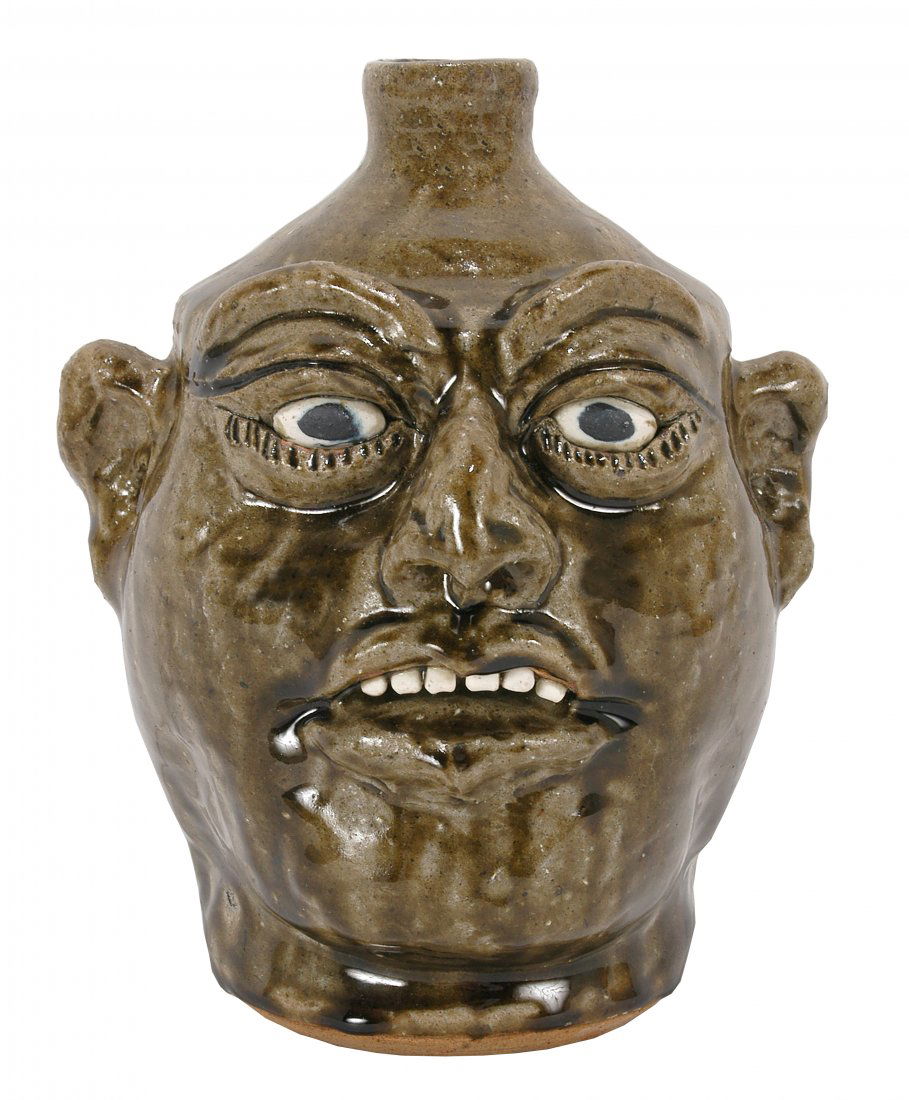 Lanier Meaders. Top-Teeth Face Jug.: Lanier Meaders. Top-Teeth Face Jug. 1988. Rare signed and dated jug. Light green swamp glaze. Mint condition. 9.5\" h. Est. $1,000-1,500. Ship: $55 Note: We had originally mistakenly placed another La