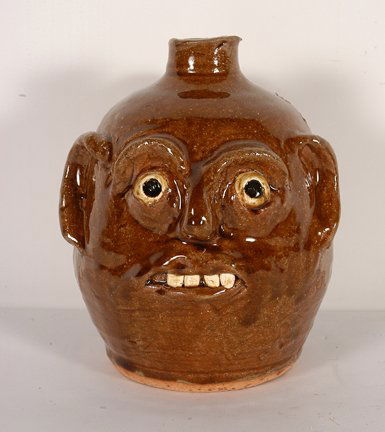 Reggie Meaders. Smiling Face Jug.: Smiling Face Jug.Ceramic. Signed in script on back. 8"h. Mint condition. Est. $200-300. Ship: $35