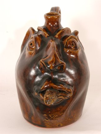 Robert Brown. Face Jug w Cigar.: Face Jug with Cigar.Ceramic. 9"h. Mint condition. Est. $200-300. Ship: $35