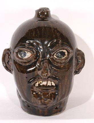 Chester Hewell. Large-Eyed Face Jug.: Face Jug.c. early 1990's. Signed. 11"h. Mint condition. Est. $200-300. Ship: $45