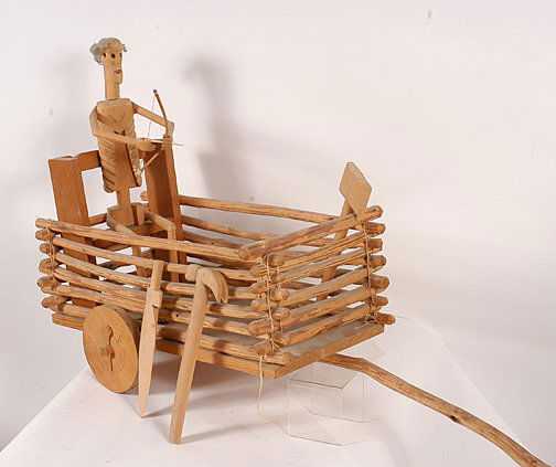 George Lopez. Death Cart Wood Carving.: Death Cart.Carved wooden construction with mixed media including wood, string, glue. Signed and dated, 3/1977. 40" long x 26"h x 13"w. "Death" holds a bow and arrow and has other tools. The arrow has