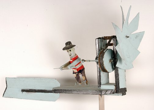 Paul Lebatard. Man on Whirligig.: Man on Whirligig.Carved and painted wood with tin blades, cloth, and mixed media. Signed, not dated. 39" long x 17"h x 12"w. Excellent condition. Provenance: The Richard Gasperi Gallery. Lebatard is l