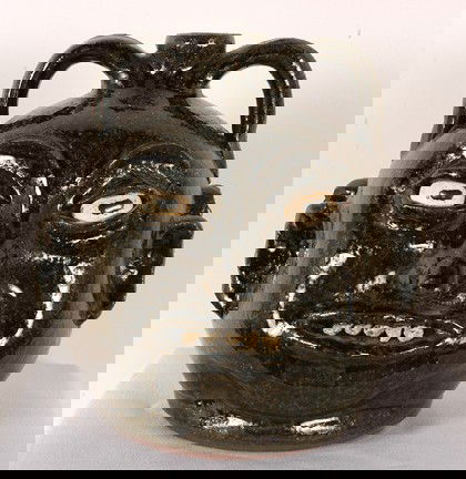 Lanier Meaders Double Rock Tooth Jug.: Ash glaze. c. 1970's. All the teeth are in place and in mint condition. There is a small chip on one ear, otherwise in mint condition. 9"h. Est. $2,000-4,000. Ship: $55