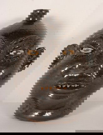 Lanier Meaders Experimental Glaze Face Jug.: Experimental Glaze Face Jug with Baby Rock Teeth. Glaze is unusual, either albany slip or some sort of experimental glaze. c. early 1970's. 11"h. Mint condition. Est. $2,000-3,000. Ship: $50