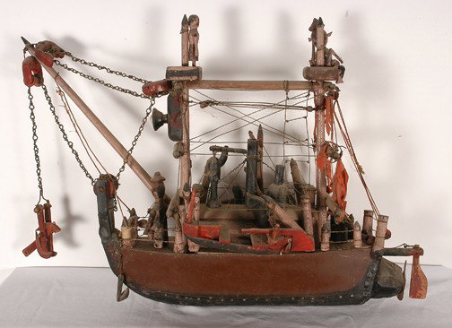 Ship Model Old Time Dredger Ship.: Strange and crazy cast of characters. Tin, wood, paint, wire, cloth and other mixed media. Early piece with lots of crazing of the paint. 23"x 31" x 13". Excellent condition. Provenance: Howard Campbe