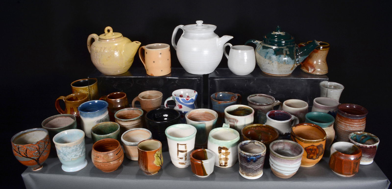 3 Teapots, Numerous Coffee & Tea Cups.: Anonymous and Marked Pottery. 3 Teapots, Numerous Coffee and Tea Cups. All in great to excellent condition. Some are signed. Average coffee mug is 4"h. Est. $100-200. Ship: $200
