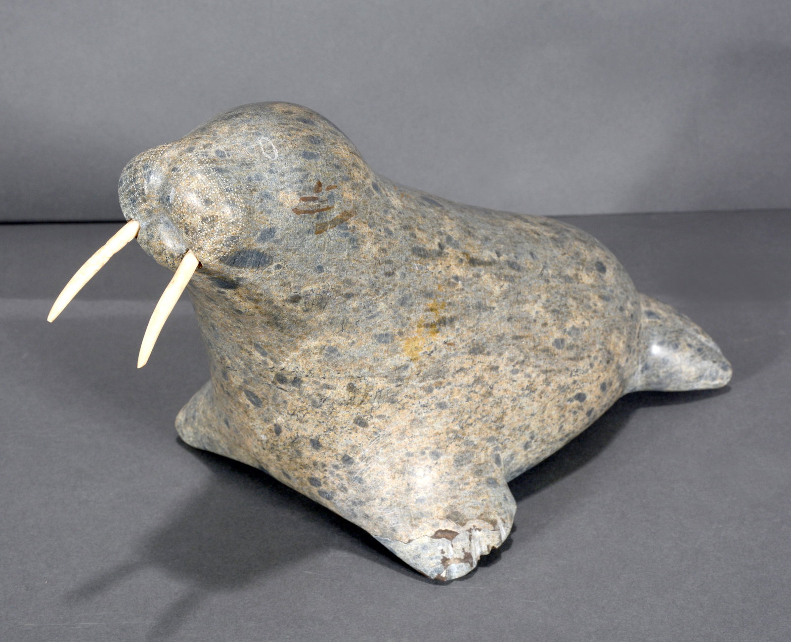 Inuit Artist. Carved Soapstone Walrus.: Unknown Inuit Artist. Carved Soapstone Walrus. Carved soapstone with bone tusk. Minor surface scratches, otherwise excellent condition. 13" x 7" x 8". Est. $300-500. Ship: $55
