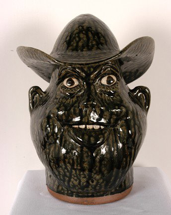 Clete Meaders, Jr. Face Jug With Hat.: Face Jug with Hat. Gorgeous tobacco-spit glaze. 12.5"h. Mint condition. Est. $200-300. Ship: $65
