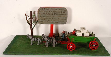 Josephus Farmer Dixieland Land of Cotton.: Dixieland Land of Cotton. Carved and painted wood. Scene includes horses, wagon, cotton plants and a plaque about Eli Whitney and Negro labor. Excellent condition. 18.5" x 48" x 23". Provenance: Dr. R