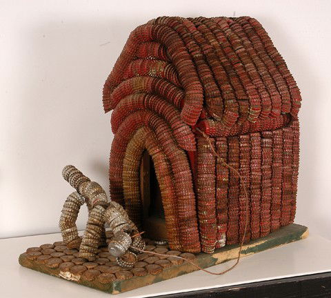 Clarence Woolsey Dog & Dog House.: Dog and Dog House. Bottlecap, paint and wood construction. 21" x 10" x 17". The dog needs a little T.L.C. Provenance: Shelley Zegart. Est. $500-1,000. Ship: $75