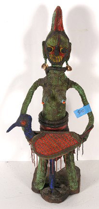 Yoruban Beaded Female Figure.: Rare beaded Yoruba female figure. It is made of wood, beands, cowrie shells and metal. She is holding a beaded bird. 24" h x 11". Excellent condition. Est. $200-400. Ship: $55