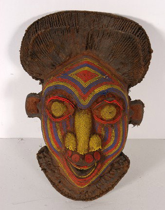Beaded Bamum Tribe Mask Cameroon.: This mask is carved of wood with an oily and earthen patina, completely covered in beads, all set in a dizzying pattern and great design.16" x 12". Great condition. Est. $200-300. Ship: $40