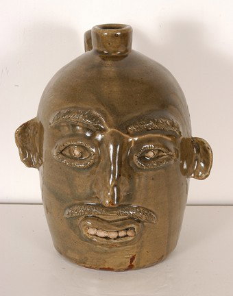 Jerry Brown. Face Jug.: Green glaze. Signed, "Jerry Brown, Hamilton, AL." 10"h. Mint condition. Est. $100-200. Ship: $45
