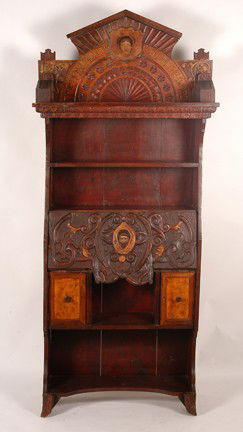 Drop Top Secretary.: The Pen Is Mightier Than The Sword - Carved wood with polychrome. Various types of carvings and inlaid wood. Carved head on front with decorated scroll work and full-figure man and woman on sides. Hea