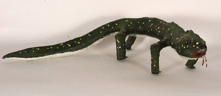 Felipe Archuleta. Iguana.: 7/12/1980. Carved and painted with plastic nails and tongue. Signed and dated. 26"long. Excellent condition. Est. $800-1,200. Ship: $55