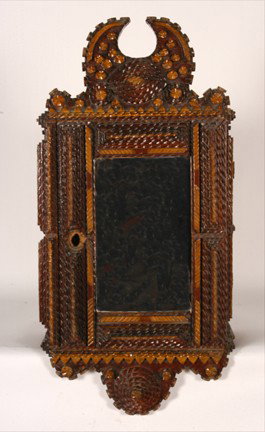 Tramp Art. Highly Stylized Mirror Cabinet Case.: Carved and stained wood with some paint. Excellent condition. 12" x 8"x 24"h. Provenance: The George and Sue Viener, Ex. Clifford Wallach Collection. Est. $800-1,200. Ship: $85