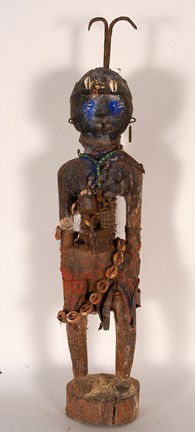 Fon Bocchio Fetish from Benin.: Mixed media, shells, etc. 24" h x 5" x 4". Est. $100-200. Ship: $45