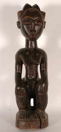 Baule Tribe Female Figure.: PNG tribe "Clan Spirit figure", Mimdimbit village, middle sepik river, New Guinea. 25.5" x 7.25" x 7.25". C. mid 20th century. Natural wood splits, fair condition. Carved wood. Est. $100-200. Ship: $5