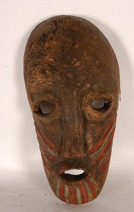 Dan Tribe Guese Mask.: Carved and painted wood. Fair condition. 15" x 5" x 7". Est. $100-200. Ship: $35. Zaire, Africa. Painted ridges in red and a light rubbed white color adorn the cheek and chin. The overall mask is very