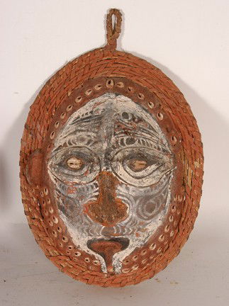 New Guinea Overmodelled Mask.: Turtle shell and paint. Missing nose and left ear. Poor condition. 12" x 8" x 3.5". Est. $100-200. Ship: $25. Ancestral mask from Tanbanum Village in the Middle Sepik. The clay face is modelled over a