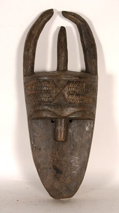 Toma Tribe Poro Mask.: Carved wood. Stain. Good condition. 16" x 6" x 4". Est. $100-200. Ship: $35. - Black mask with flat oval face; tiny, circular eyes; linear nose; facial scarification and keloids on protruding forehead