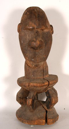 Sepik Tribe Ancestor Figure.: Carved wood. Poor condition. 19" x 7" x 7". Est. $100-200. Ship: $45. Seated upon a lower sepik style stool, this is a wonderful old ancestor figure with great presence. Rendered with an oversized hea