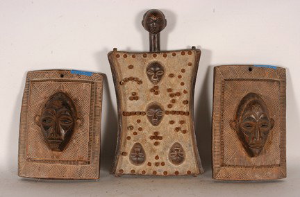 Three African Masks.: Carved and painted wood. 15" x 8" x 2". Est. $100-200. Ship: $45. Songye tribe carved wood plaque faces - male. Beautiful wood plaques with a male face on a background of intricately decorated incised