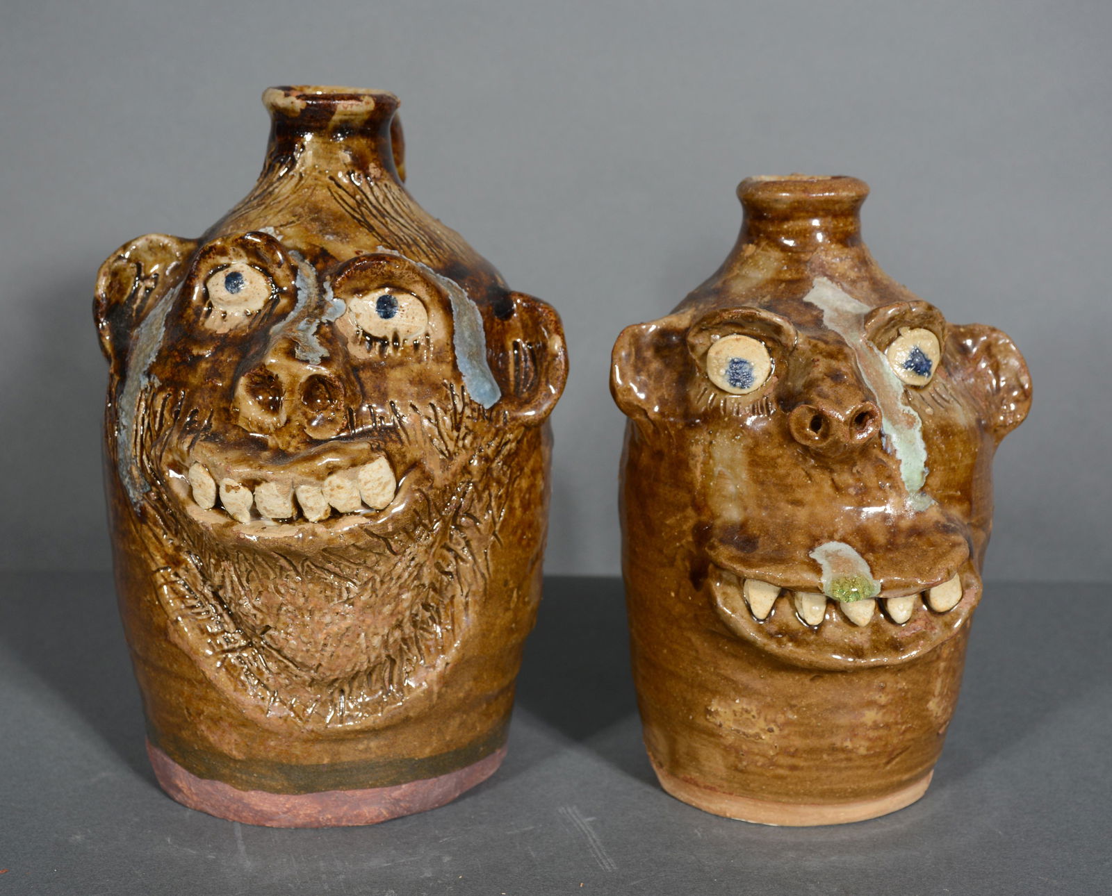 Marie Rogers. Pair of Glass Drip Face Jugs. (1 of 2)