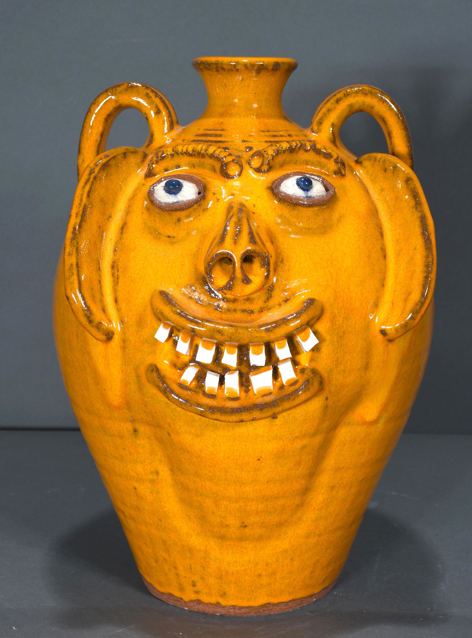 A.V. Smith. Mango Colored Face Jug. (0150) on Feb 11, 2023 Slotin