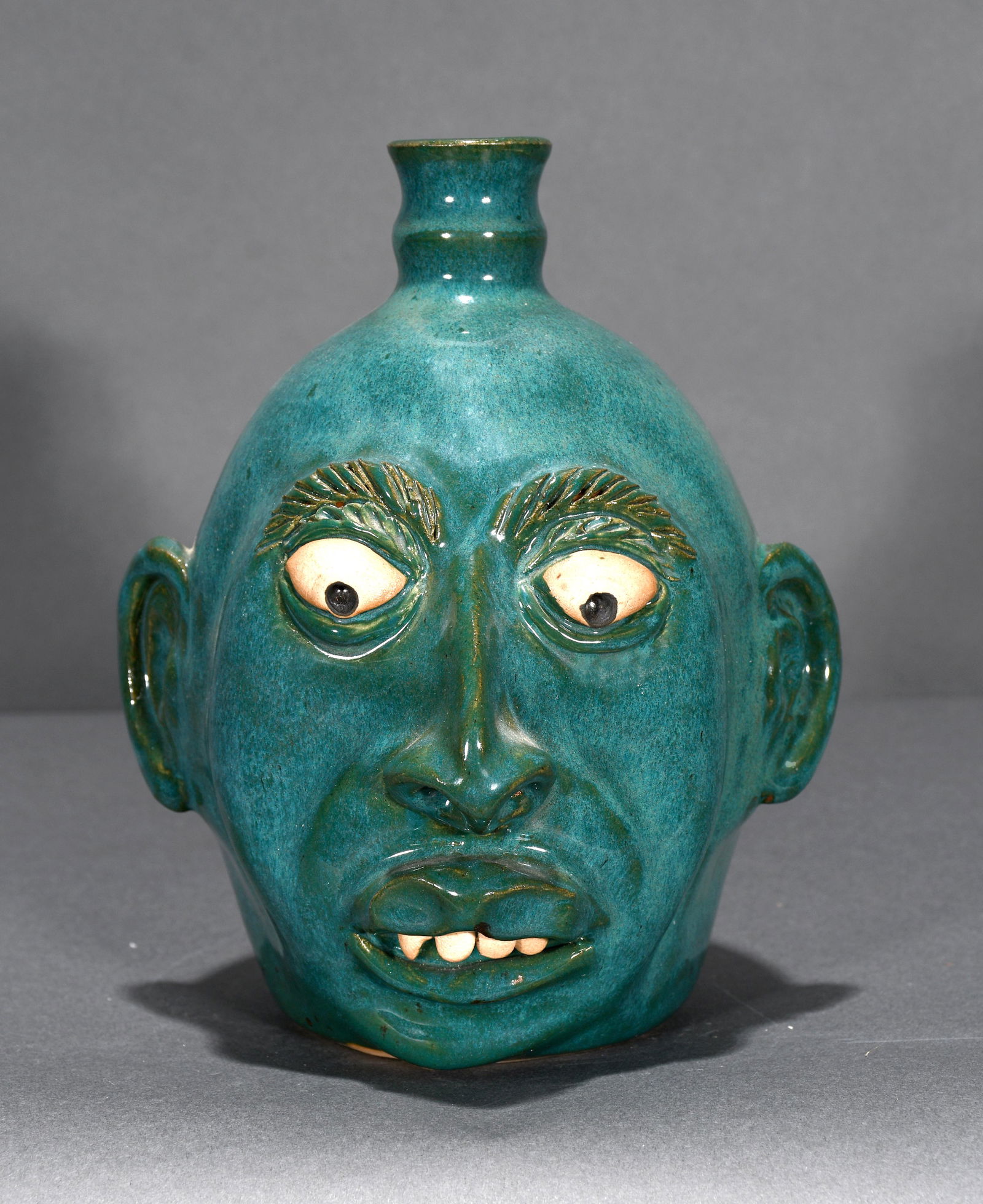 J.R. Cooper. Teal Glazed Face Jug. (1 of 3)