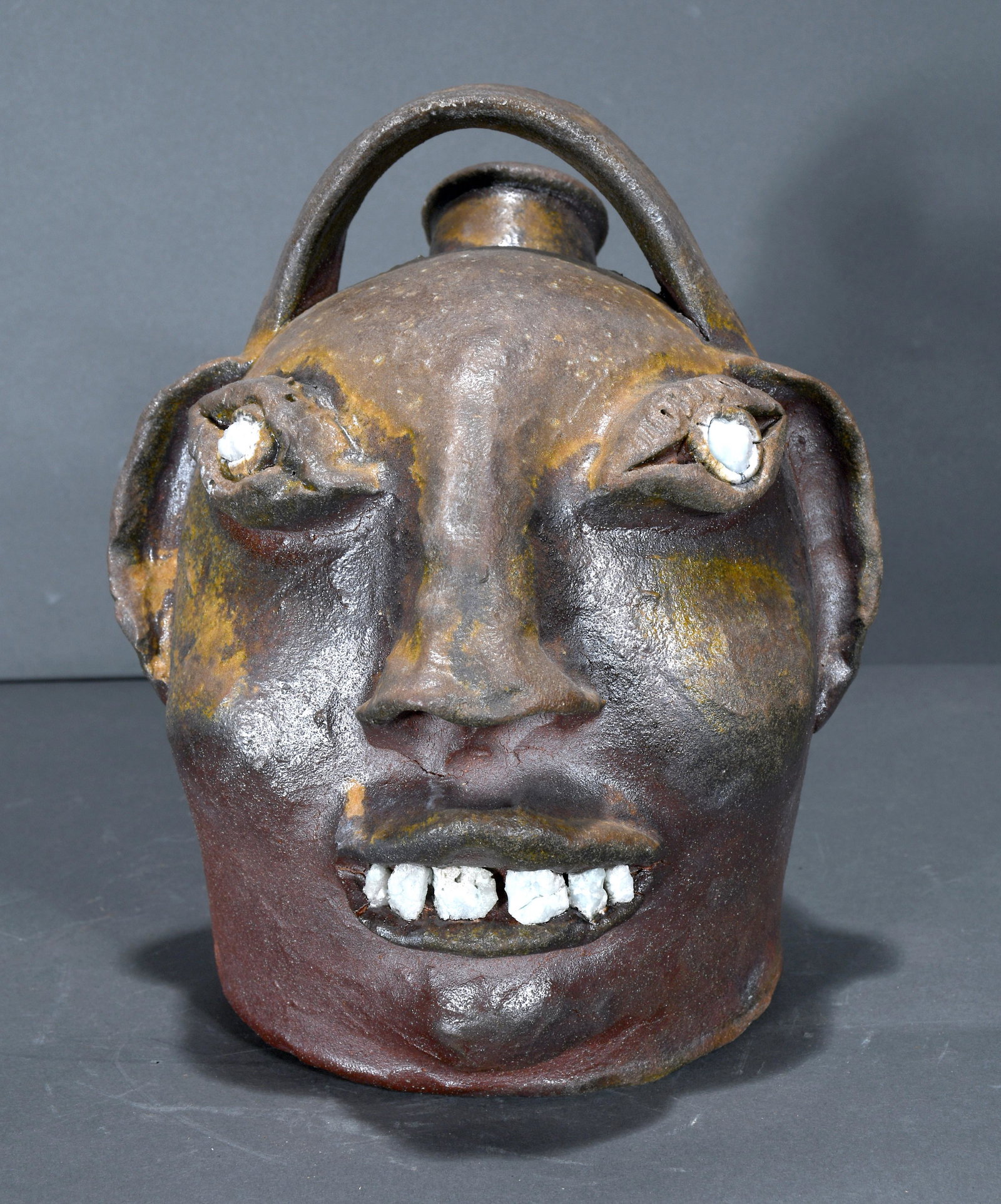 Fred Corn Face Jug.: Unknown Potter. Fred Corn Face Jug. Signed, but illegible. Titled, 'Fred Corn' in script. Rock teeth and eyes. Rough glaze, otherwise excellent condition. 9.5" h. Est. $100-200. Ship: $55