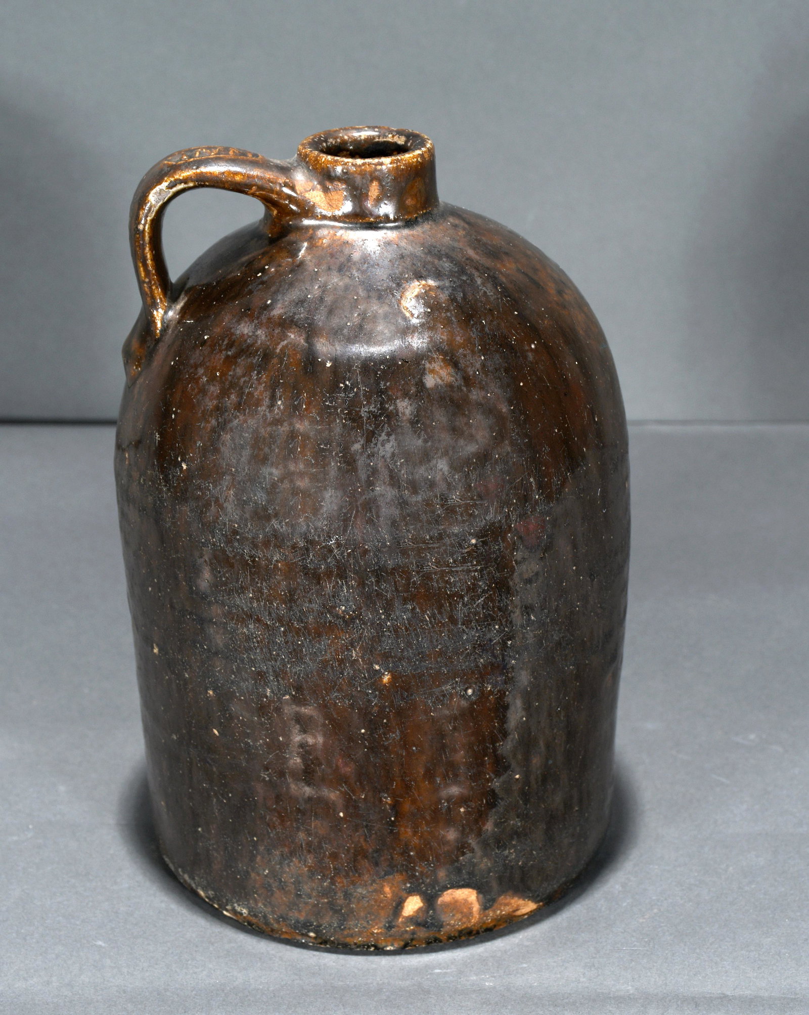 Henry Newton Long. Half Gallon Dark Jug.: Henry Newton Long. Half Gallon Dark Jug. Stamped on handle. Excellent condition. 9" h. Est. $200-400. Ship: $45