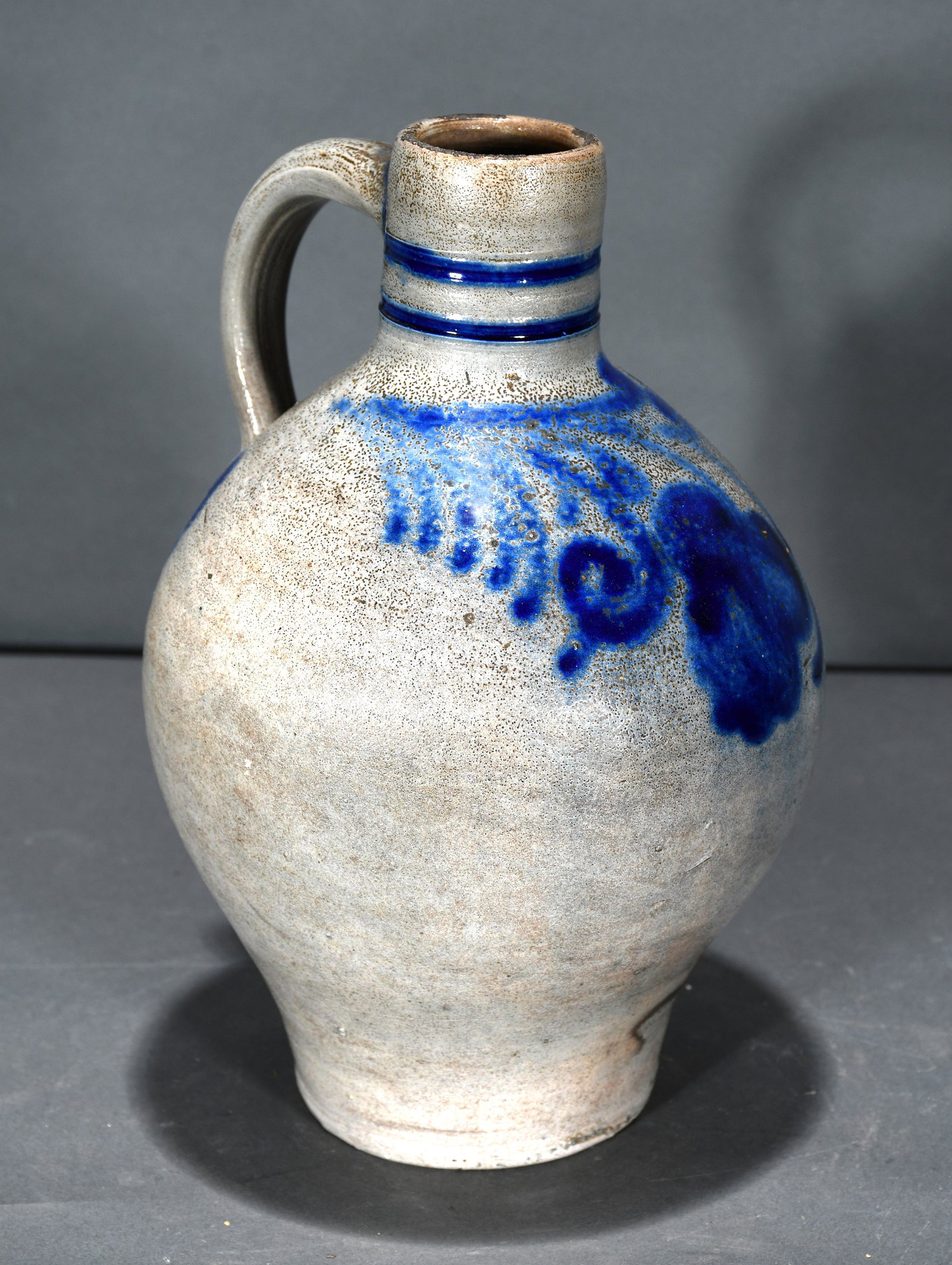 Half Gallon Salt & Bright Cobalt Decorated Jug.: Anonymous. Half Gallon Salt and Bright Cobalt Decorated Jug. Hairline crack on side, otherwise excellent condition. 10" h. Est. $100-200. Ship: $45